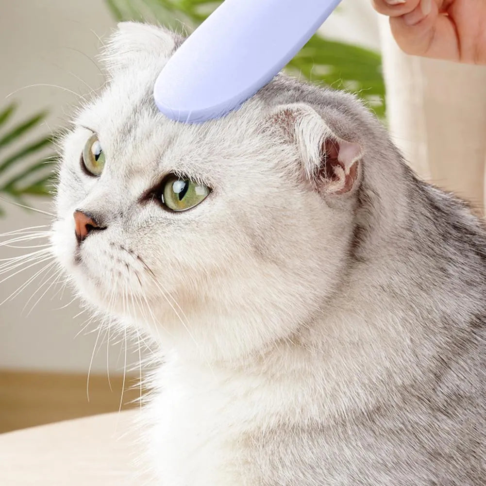 Grey and pink cat grooming comb with tongue massage design and dual-ended narrow and wide sections