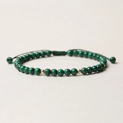 Women's malachite crystal bracelet with golden balls and handwoven design