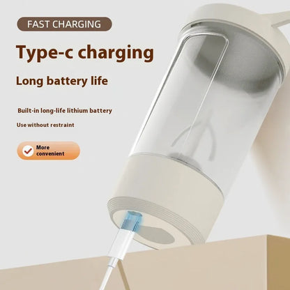 Black electric protein shaker bottle with lid and USB charging cable on a table