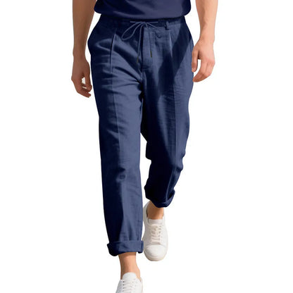 Men's light beige linen trousers with a loose straight leg and drawstring waist on a hanger.