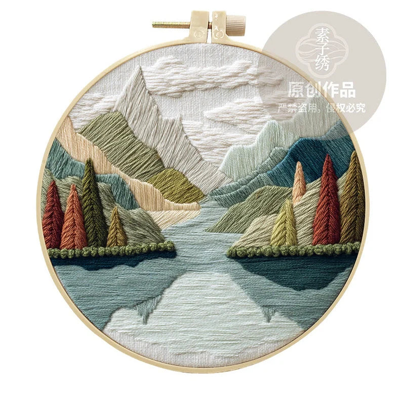 Embroidery DIY landscape kit with bamboo frame, printed fabric, thread, and needles for textile art