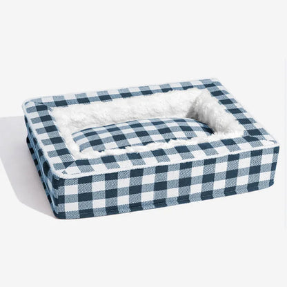 Classic plaid pattern dog kennel with removable cloth cover shown next to a matching cushion