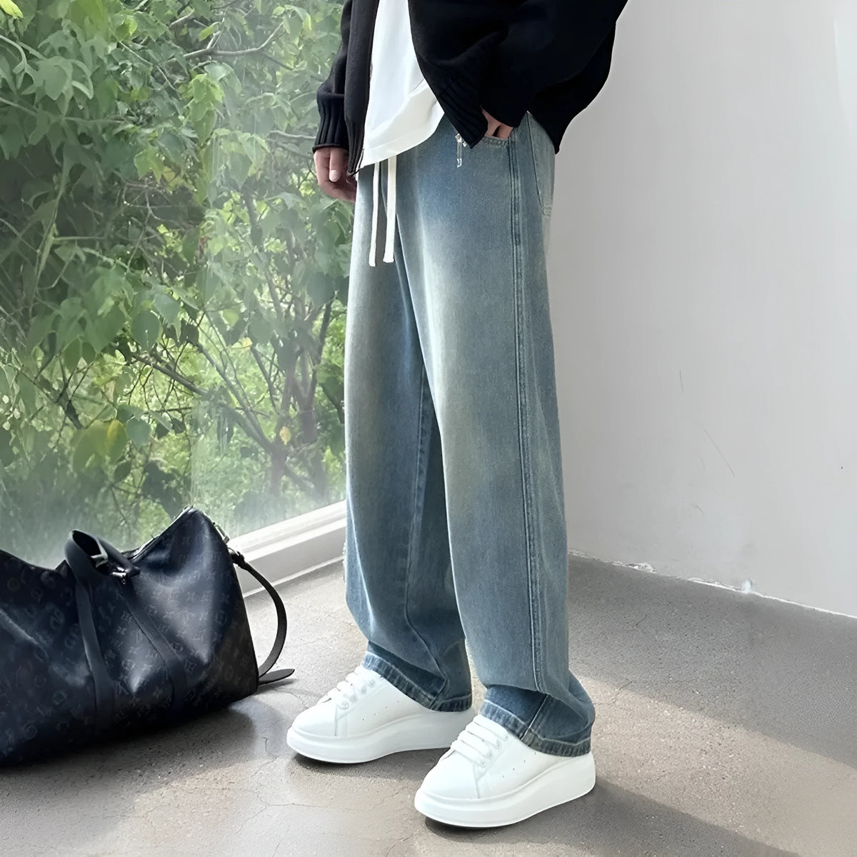 Straight-leg loose fit men's jeans in blue denim with drawstring waist for casual spring summer wear