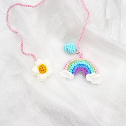 Handmade crocheted cartoon-style car pendant in wool, shown in avocado, pink rainbow, and red rainbow colour options.