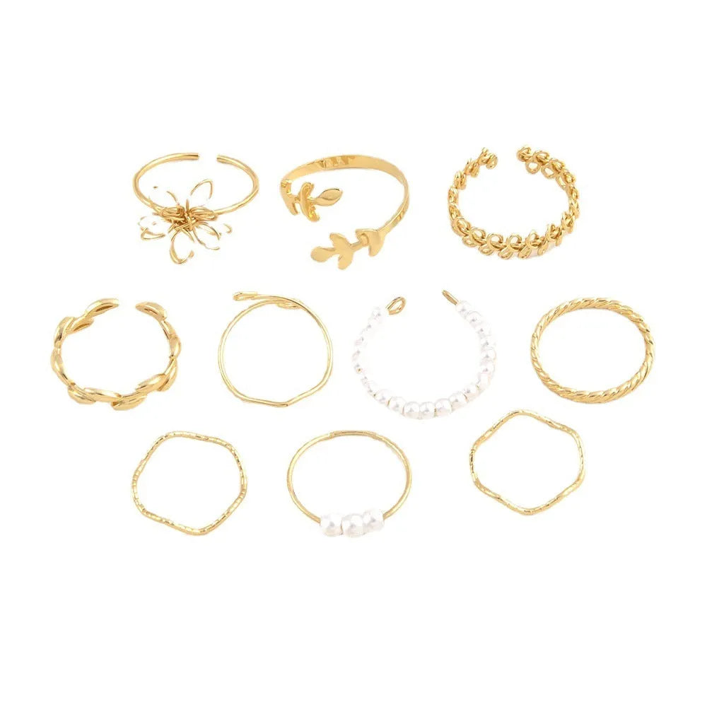 Women's gold openwork flower ring set showing detailed floral cut-out pattern and glossy electroplated finish