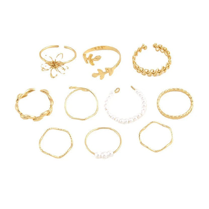 Women's gold openwork flower ring set showing detailed floral cut-out pattern and glossy electroplated finish