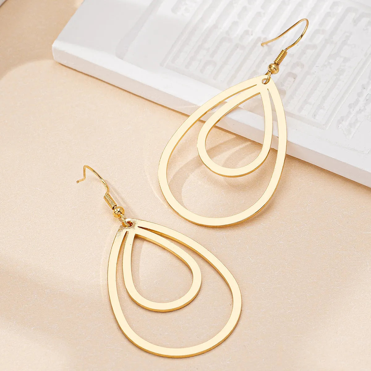 Golden yellow hollow drop earrings made from iron, shown as a single pair for everyday fashion.