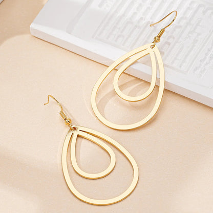 Golden yellow hollow drop earrings made from iron, shown as a single pair for everyday fashion.