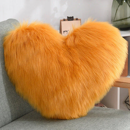 Cozy heart-shaped plush throw pillows in various colors and sizes for living room and bedroom decor