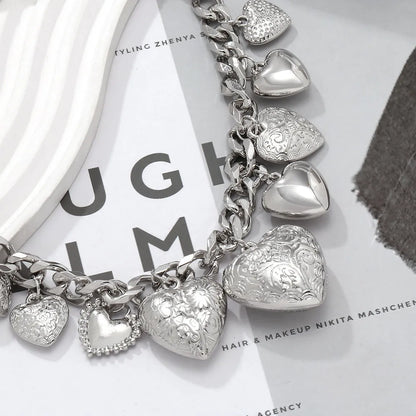 Gold carved heart pendant necklace on adjustable chain, showing exaggerated shape and textured details