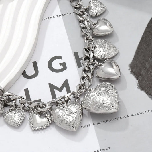 Gold carved heart pendant necklace on adjustable chain, showing exaggerated shape and textured details