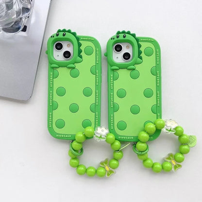 Green polka dot dinosaur silicone phone case showing back design and side protection for iPhone