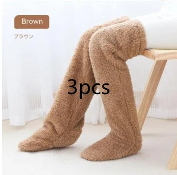 Cozy over-the-knee fuzzy socks in various colors, including brown, blue, dark gray, pink, silver, and more. Comfortable cotton design for warm, snug legs.
