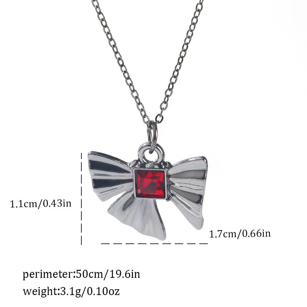 Gothic style zinc alloy necklace with bat pendant on a silver chain against dark background.