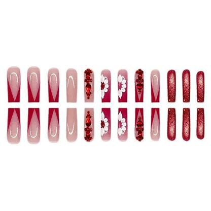 Sweet floral pattern press-on nails with red diamond accents in a long European Square shape.