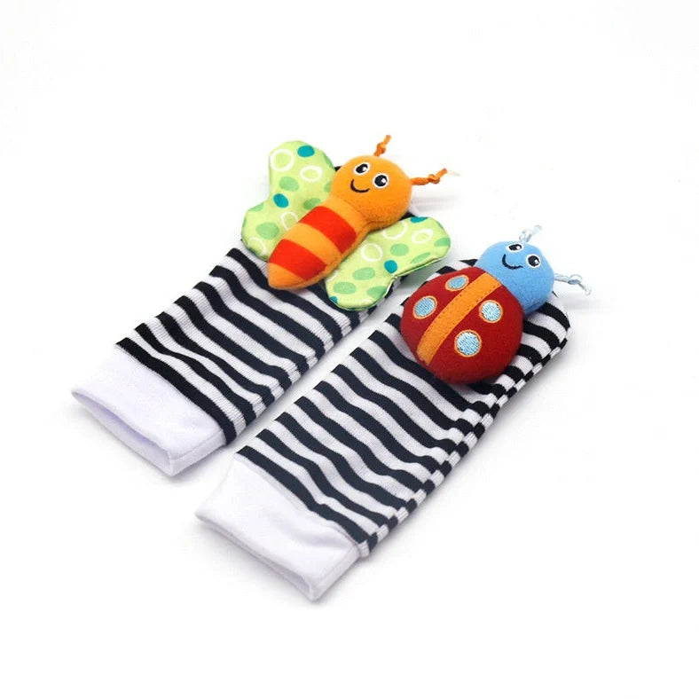 Four fabric baby socks with cartoon designs and ringing feature for infant training