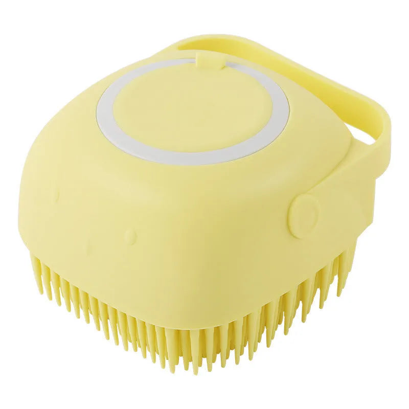 Blue silicone dog bath and massage brush held in a hand.