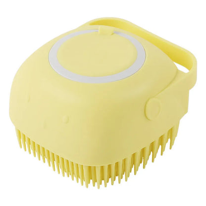Blue silicone dog bath and massage brush held in a hand.