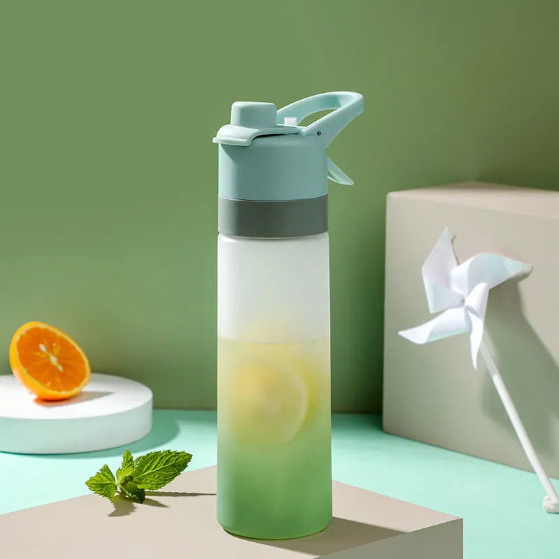 Large plastic spray water bottle with handle strap and leakproof lid in green colour.
