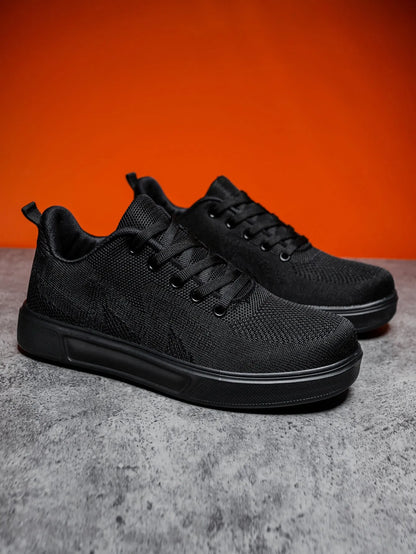 Pair of light white thick-soled casual sneakers with mesh upper and lace-up front.