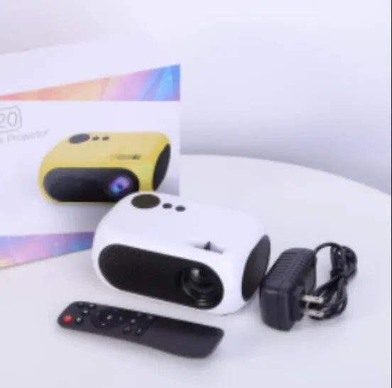 M24 gold and white portable mini LED projector with remote on a wooden table.