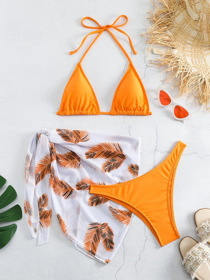 Women's orange three-piece bikini swimsuit with a matching printed gauze skirt laid flat.