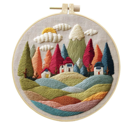 Embroidery DIY landscape kit with bamboo frame, printed fabric, thread, and needles for textile art