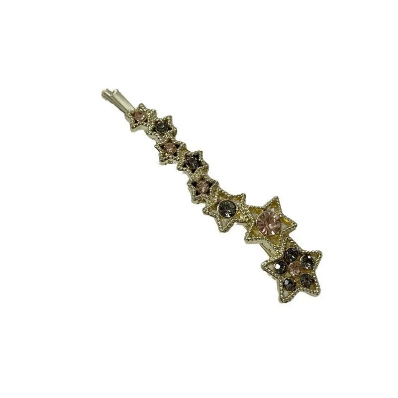 Gold electroplated hair barrette with a rhinestone five-pointed star, broken clip style for bangs.