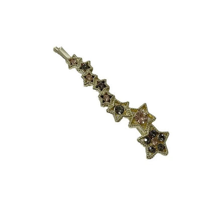 Gold electroplated hair barrette with a rhinestone five-pointed star, broken clip style for bangs.