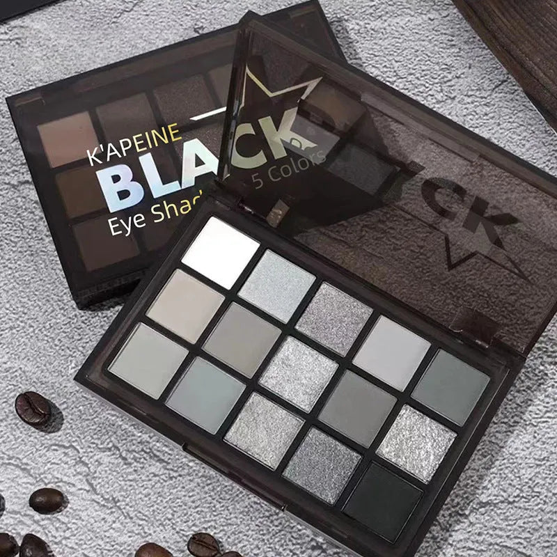 Open 15-colour eyeshadow palette showing shimmer and matte pans in browns, blues, and earth tones