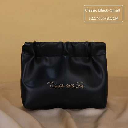 Leather travel toiletry bag with dry-wet separation compartments in caramel mocha colour with letter detailing