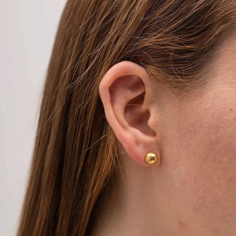 Stainless steel ball stud earrings with 18K gold or silver electroplating, available in 3mm, 4mm, 5mm, and 6mm sizes for a minimalist, geometric design that complements various outfits.