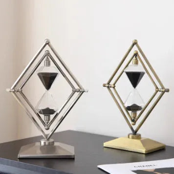Glass sand timer with zinc alloy metal ornaments in bronze or silver colours, showing sand flow for timing.
