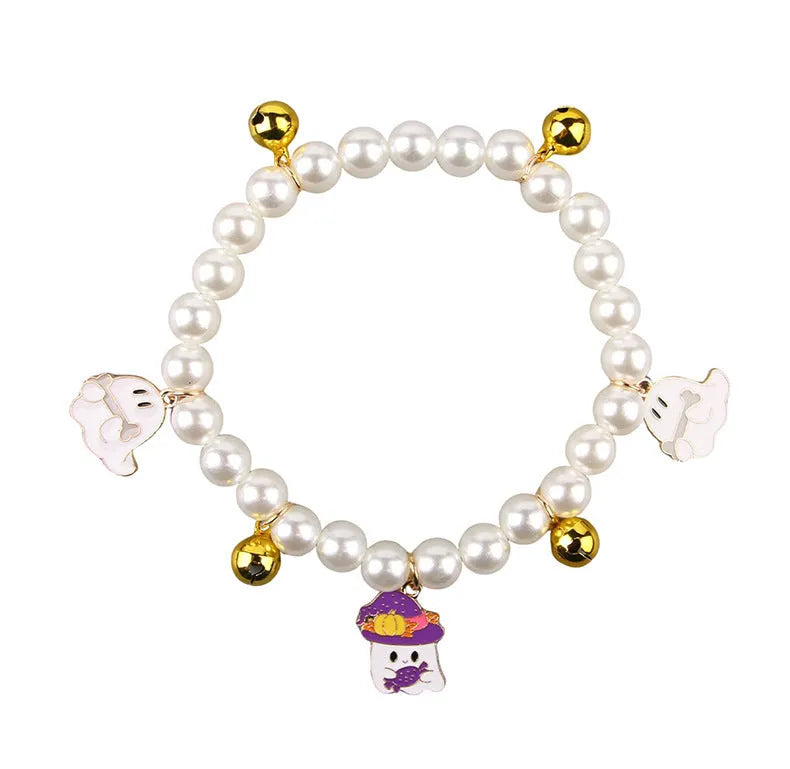 Halloween cat collar with simulated pearls and pumpkin-shaped charms in purple ghost, skull, and smiling designs.