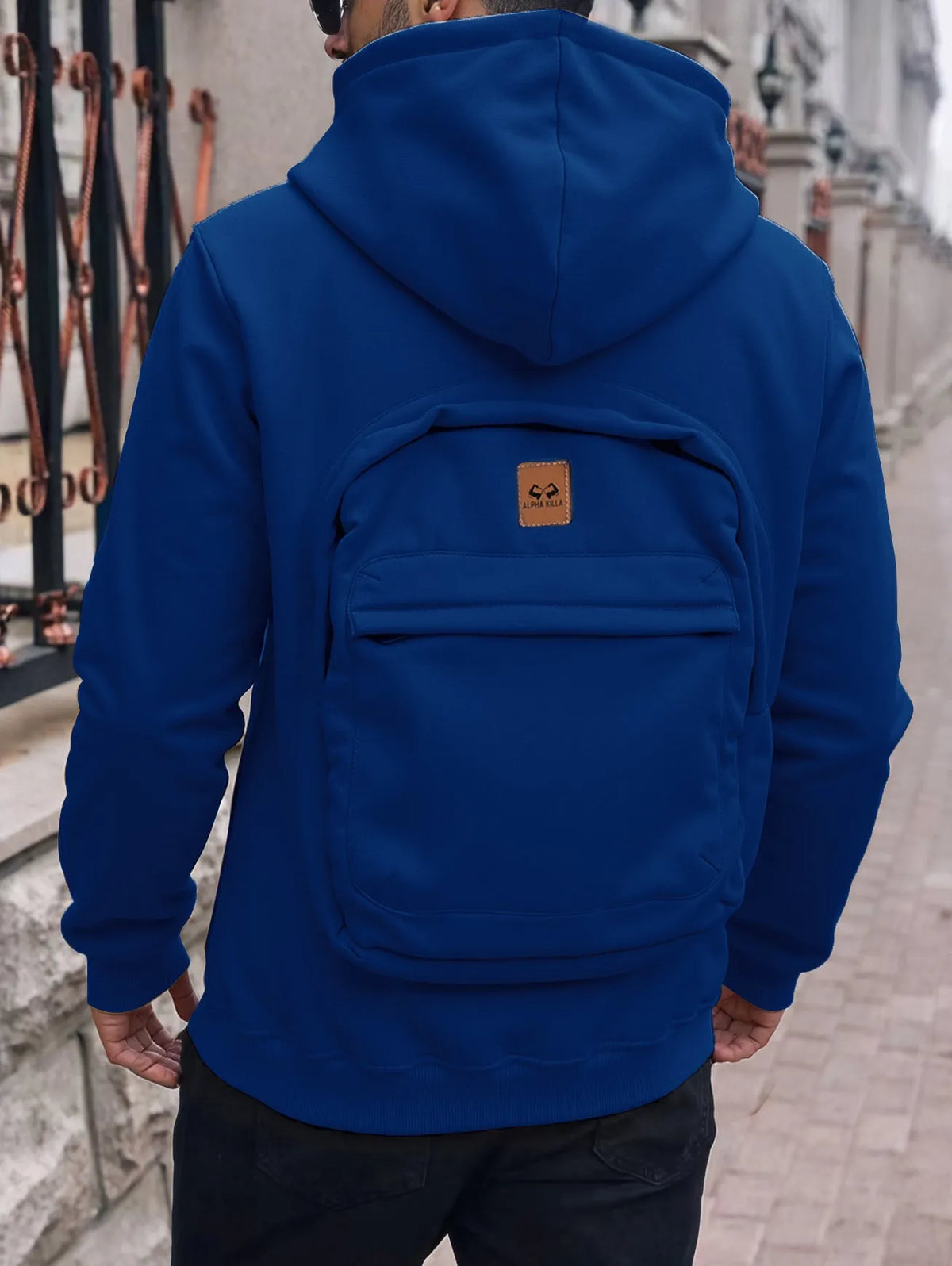 Men's loose-fit hoodie cardigan sweater with back schoolbag design and stick pocket in light grey, black and blue.
