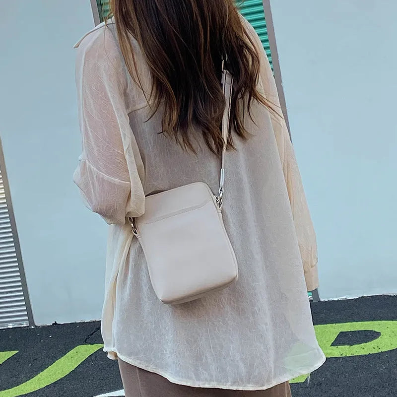 Solid colour mobile phone bag with adjustable strap showing 14.5x5.5x19cm dimensions and PU material construction