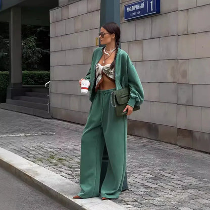 Green women's thermal sweater with front zipper and stand collar, paired with matching trousers