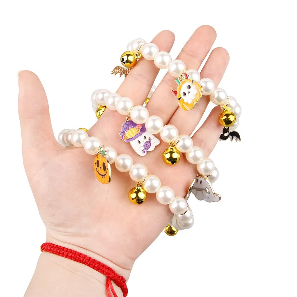 Halloween cat collar with simulated pearls and pumpkin-shaped charms in purple ghost, skull, and smiling designs.