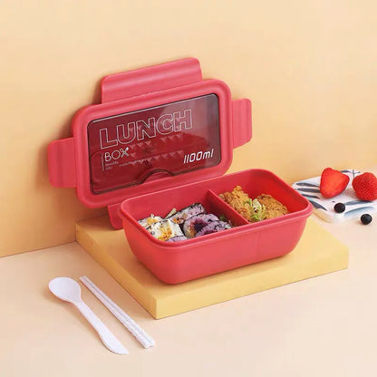 Green four-compartment plastic bento box with secure lid, showing internal partitions for separate food storage.