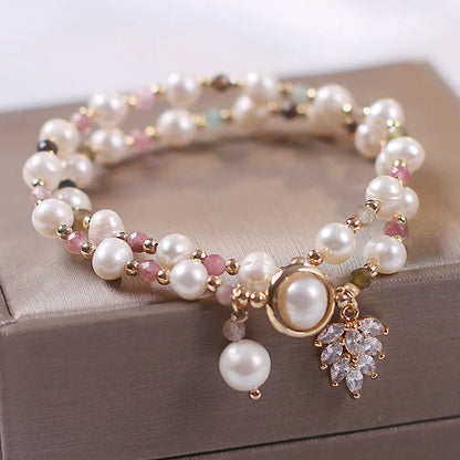 Double-layer strawberry quartz crystal bracelet with lucky cat charm and red cat's eye flowers design.
