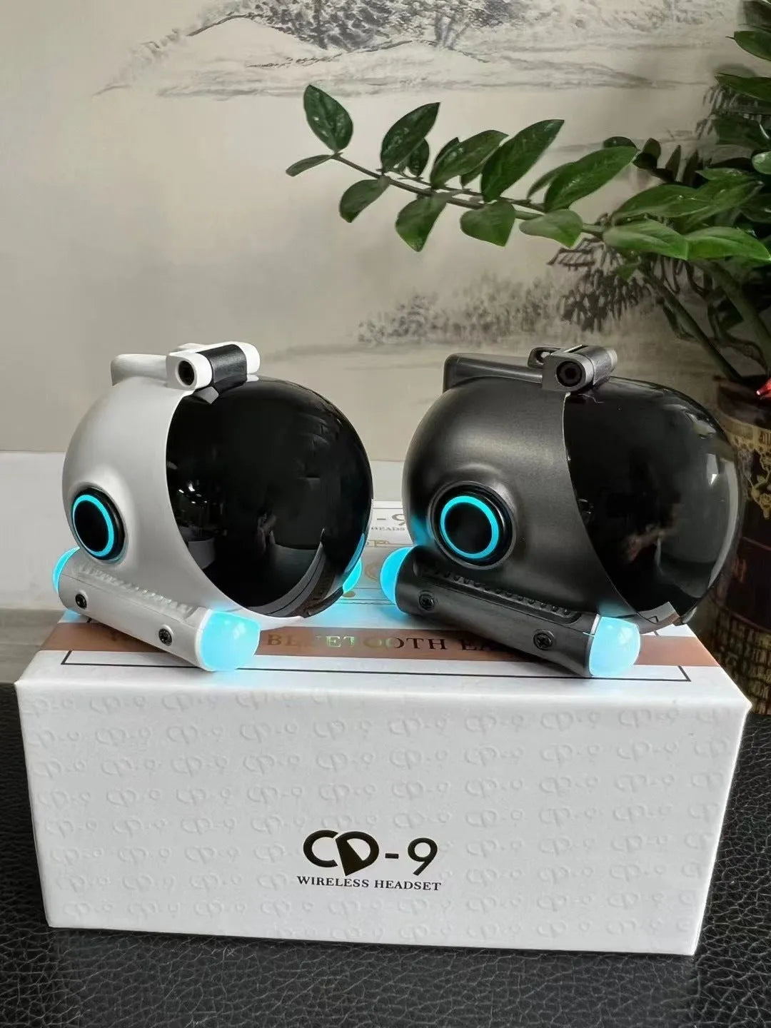 Black wireless Bluetooth sports headset with clip-on earhook design on white background