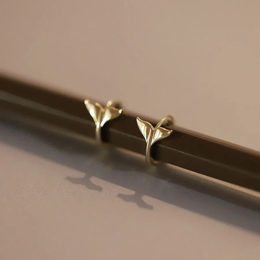 Pair of S925 sterling silver fishtail earrings with 14k gold plating in gold colour.