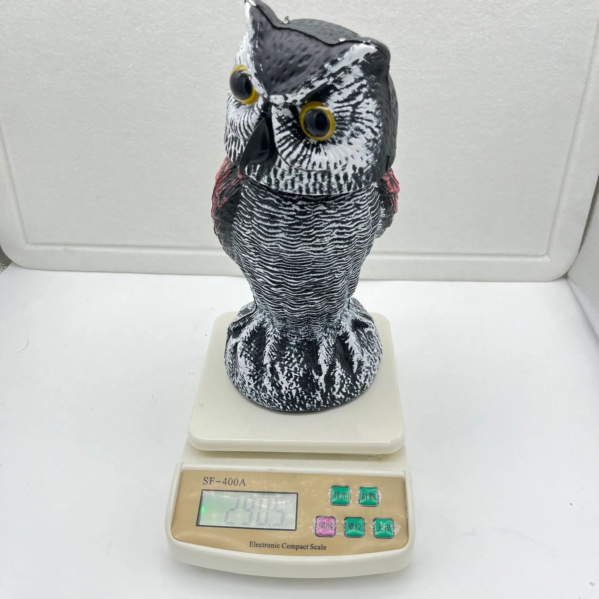 Set of artificial owl bait ornaments with shaking heads for scaring birds outdoors.