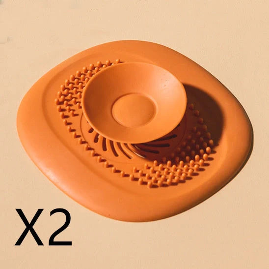 TPR vortex design sink drain cover in twilight orange, quiet blue, mango yellow, and gentian green