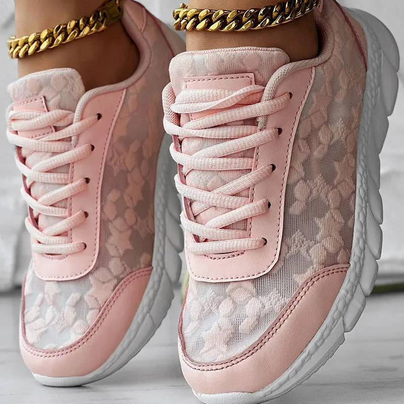 Women's canvas sports shoes in white with round toe and flat heel design on a light background