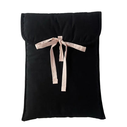 Women's black quilted laptop bag with striped pattern and ballet bow, showing smooth nylon interior