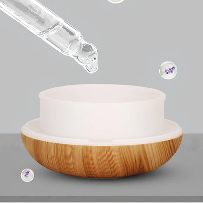 Round wood grain humidifier with USB cable and single mist outlet on light oak finish
