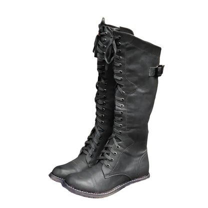 Women's black knight ankle boots with a cross strap fastening detail.