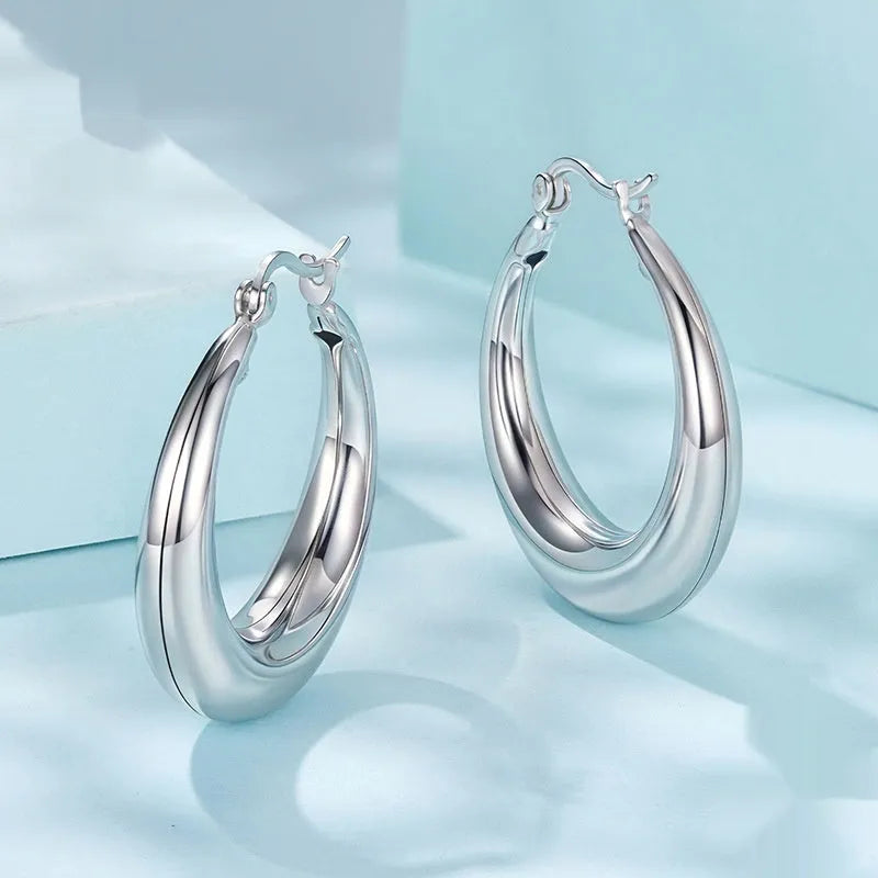 Copper alloy ear clip earrings with geometric ring design and silver posts in three sizes.