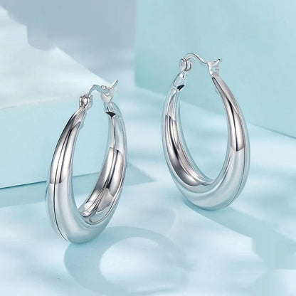 Copper alloy ear clip earrings with geometric ring design and silver posts in three sizes.